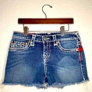 True religion jeans girl shorts with white stitches .
